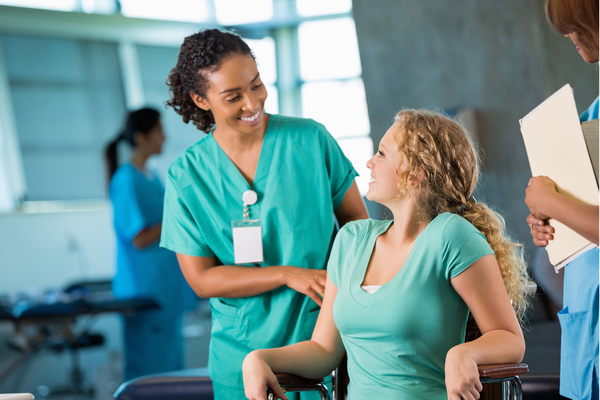 A nurse and patient talking in an office setting.