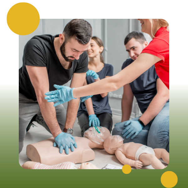 A group of people with gloves on and hands touching cpr dummies.