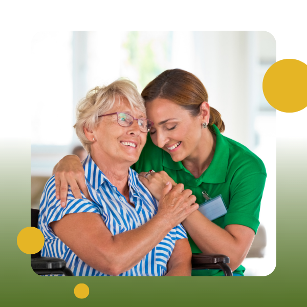 A woman hugging an older lady in a wheelchair.