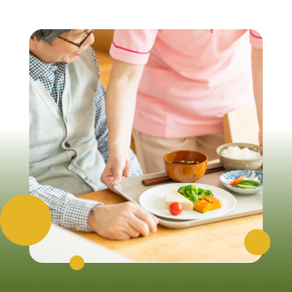 A man and woman preparing food on a table.